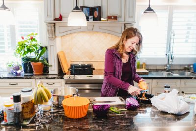 Pain Clinic patient, Sharon prepares dinner in her kitchen