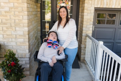 Meric and his mom Lisa outside of their home